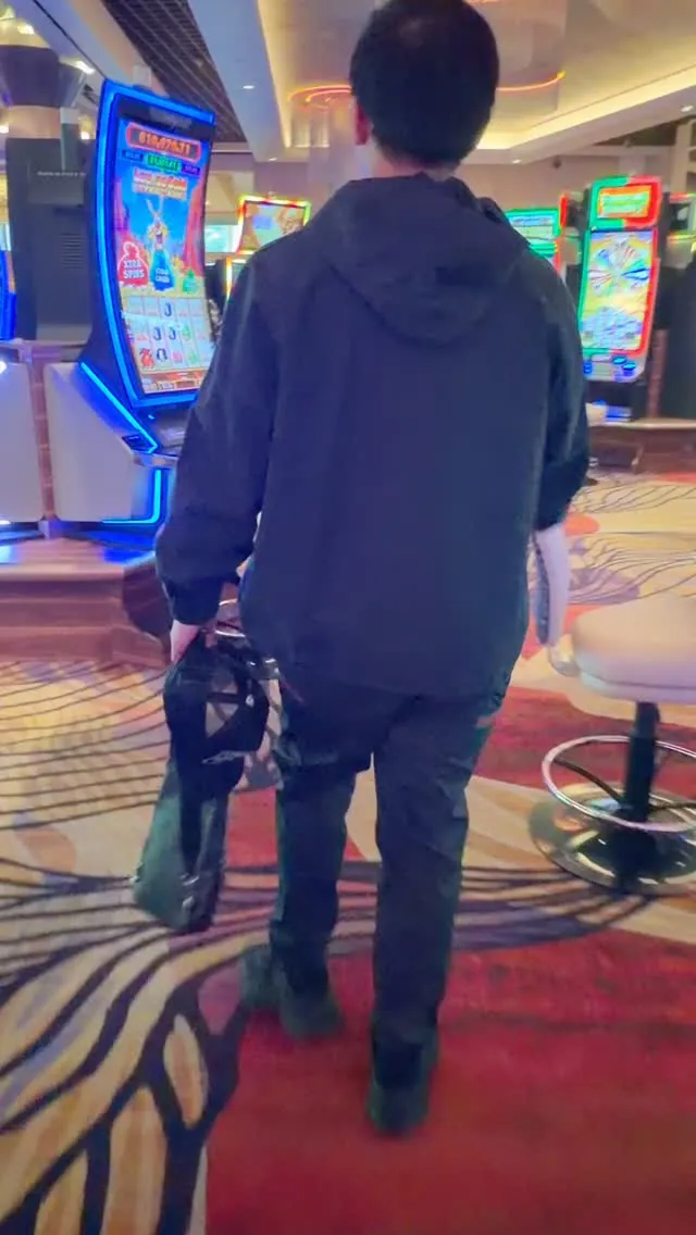 Thomas walking through a casino in a frame from The Slots Comeback